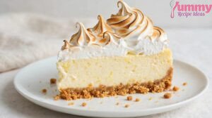 Slice of Gordon Ramsay lemon meringue cheesecake with torched meringue peaks